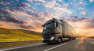 Lorry on a road with sunset behind it Lorry on a road with sunset behind it