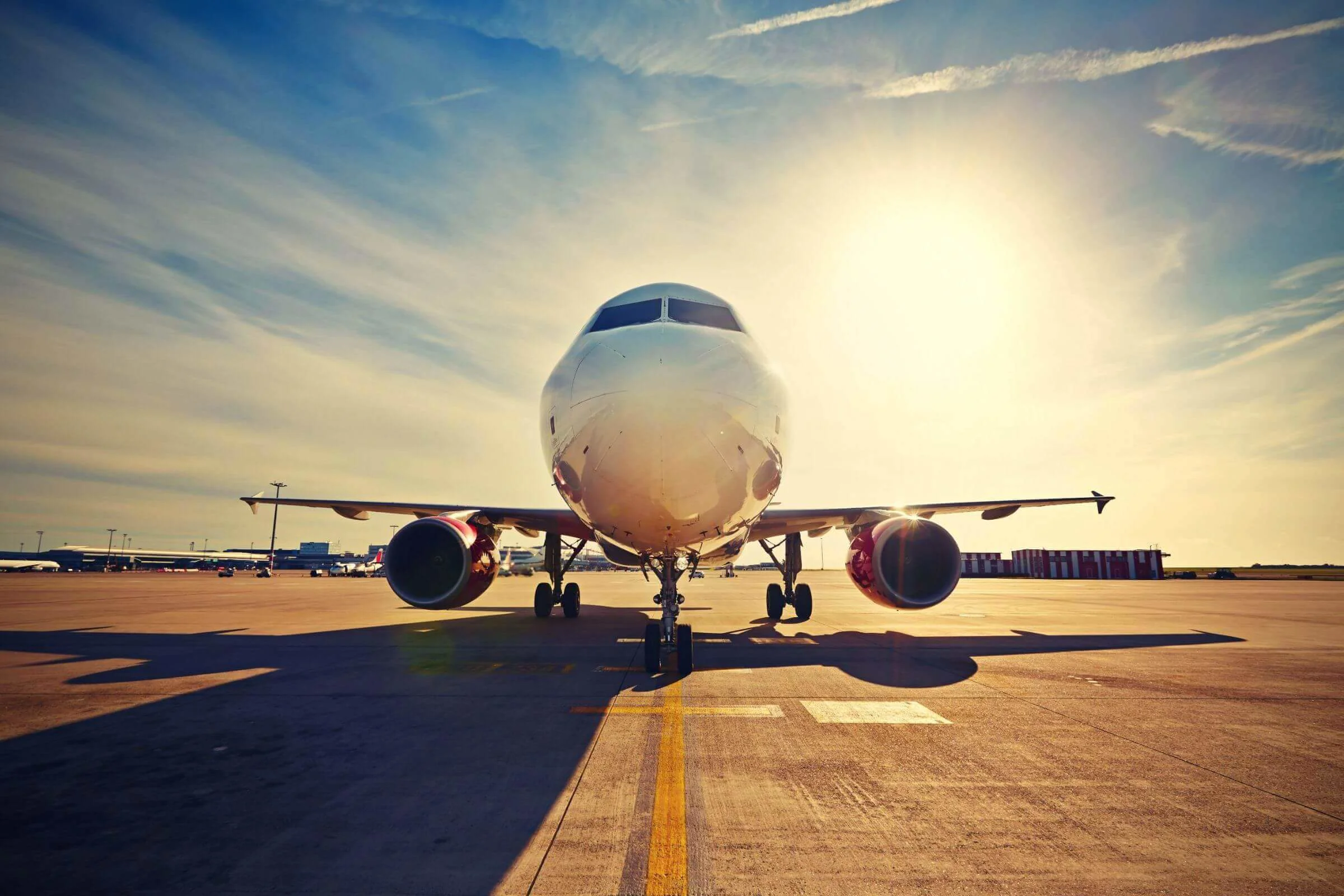 Picture of aeroplane front on with sunset behind it